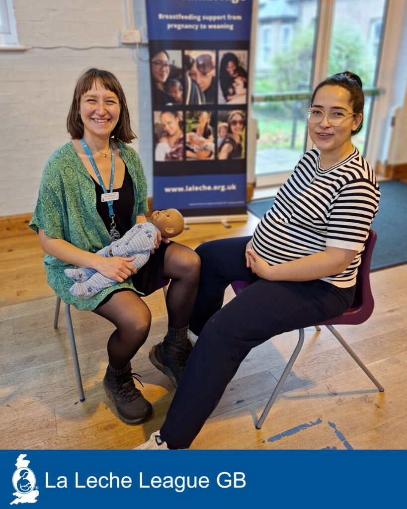 Image 4 An LLL Leader sits with a doll on her knee, next to a pregnant woman, both are smiling at the camera.